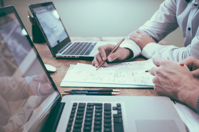 Quality manager reviewing ISO 9001 certification documents and performance charts