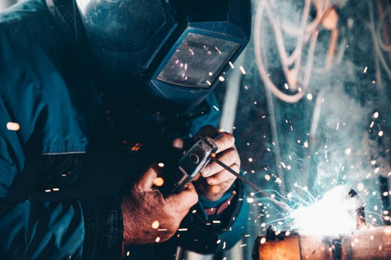 Welder at work on steel fabrication that will be checked with NDT methods